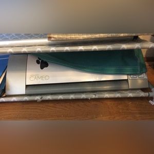 Euc silhouette cameo with cord, cover, extra blades, cutting mat, and vinyl.